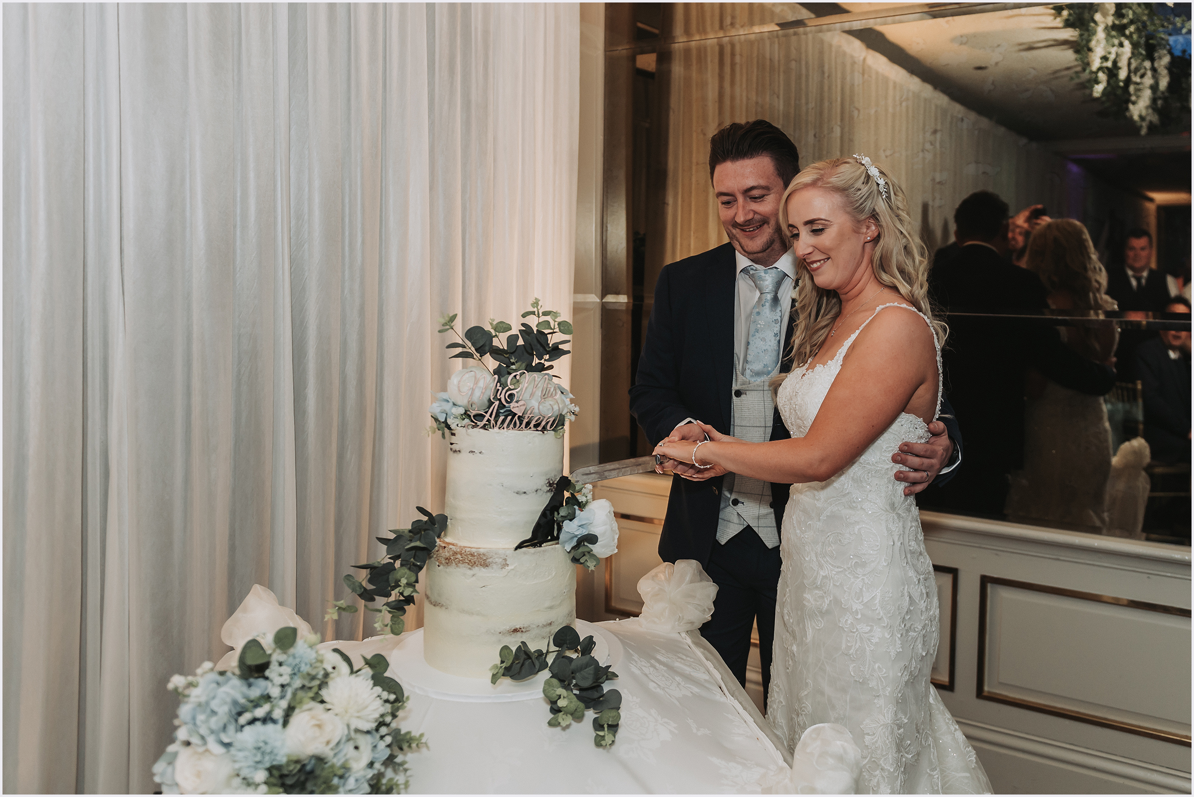 Bride and groom cutting the cake during their evening reception at The Grosvenor Pulford Hotel and Spa.