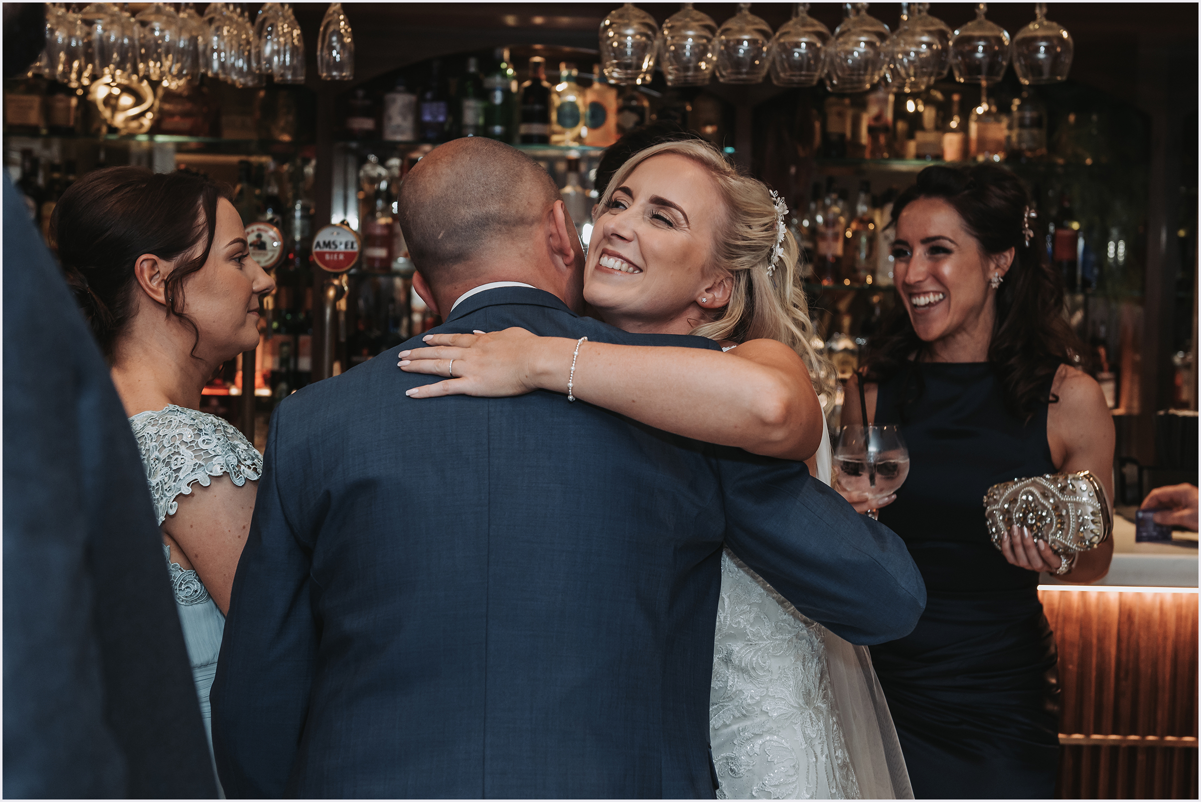 A bride hugging one of her wedding guests during the drinks reception at her wedding at The Grosvenor Pulford Hotel and Spa.