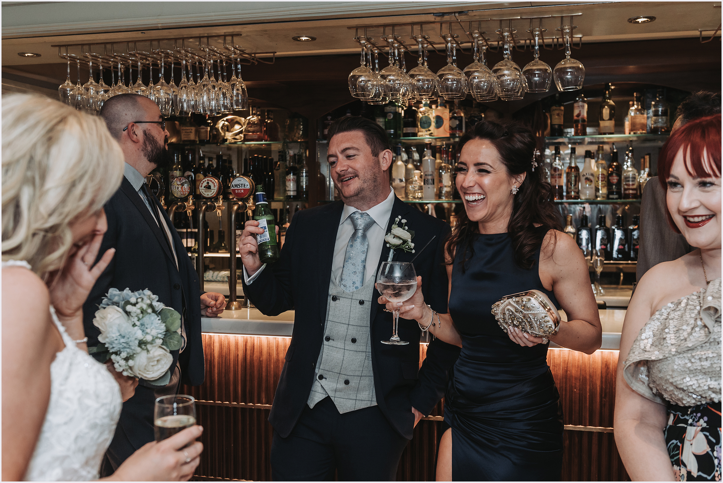 wedding guests sharing jokes during  with the bride and groom during the drinks reception at the Grosvenor Pulford Hotel and Spa
