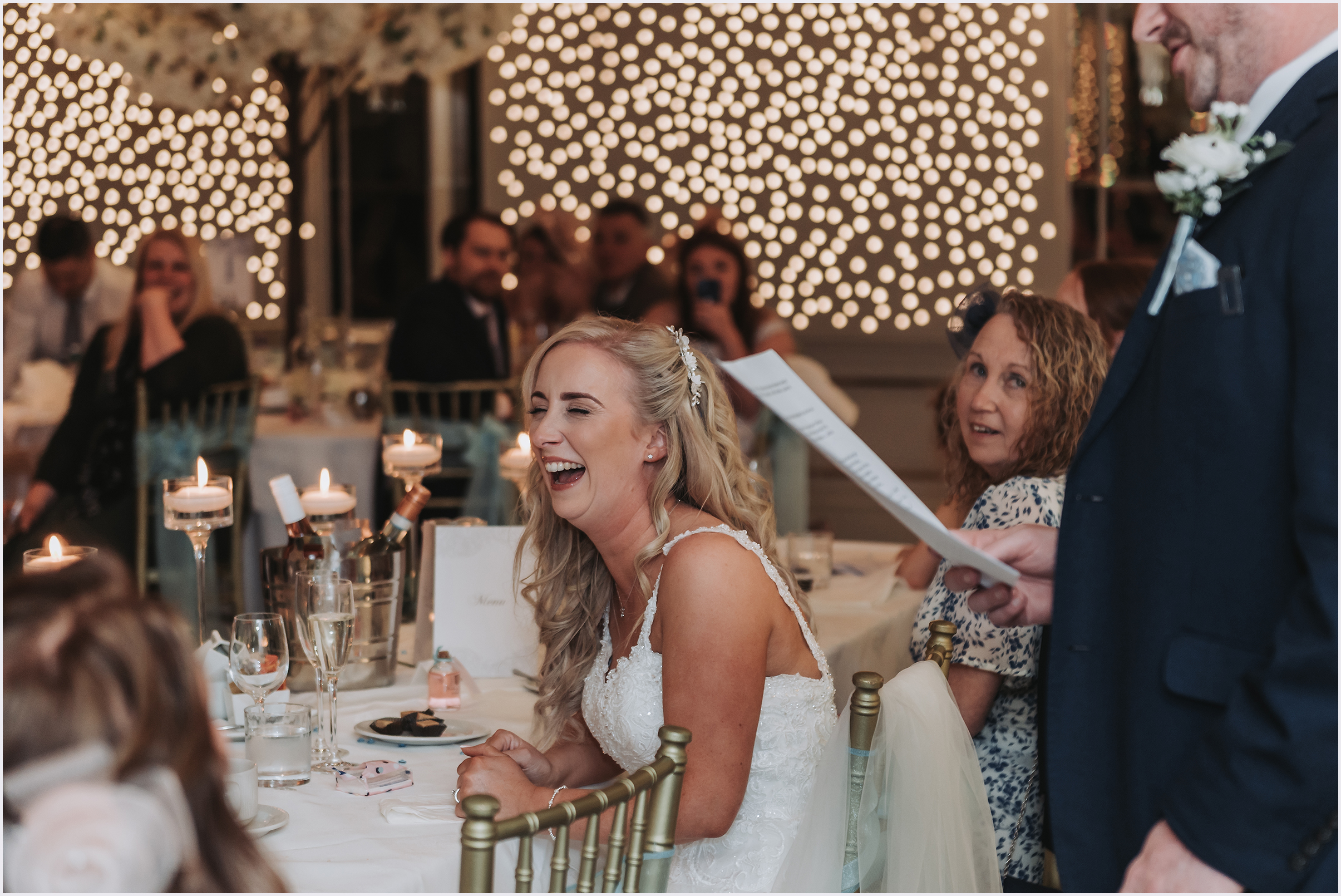 A bride laughing out loud at a joke during the speeches at The Grosvenor Pulford Hotel and Spa