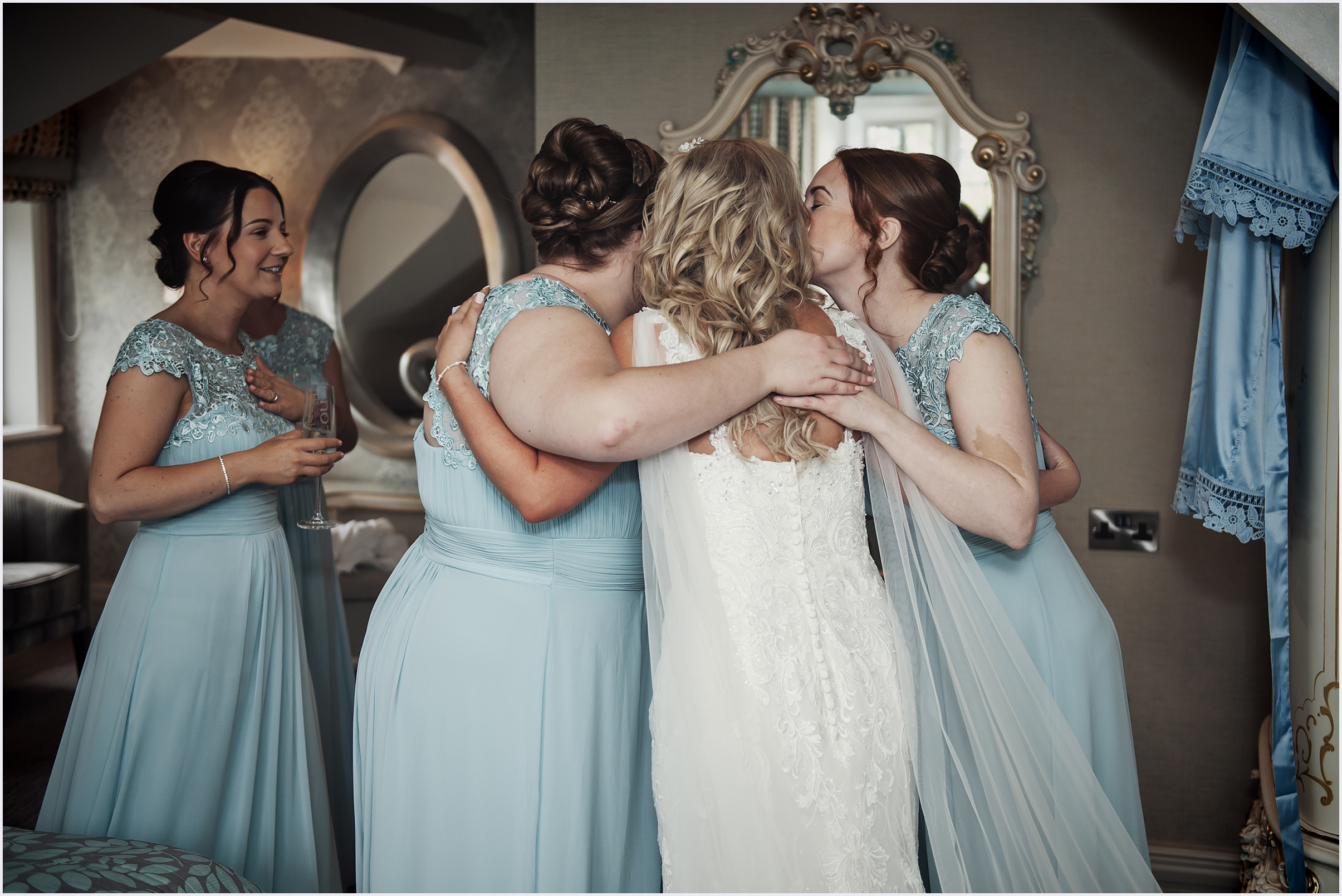 Bridesmaids embrace the bride before her wedding ceremony.  Image captured by Cheshire wedding photographer Helena Jayne Photography