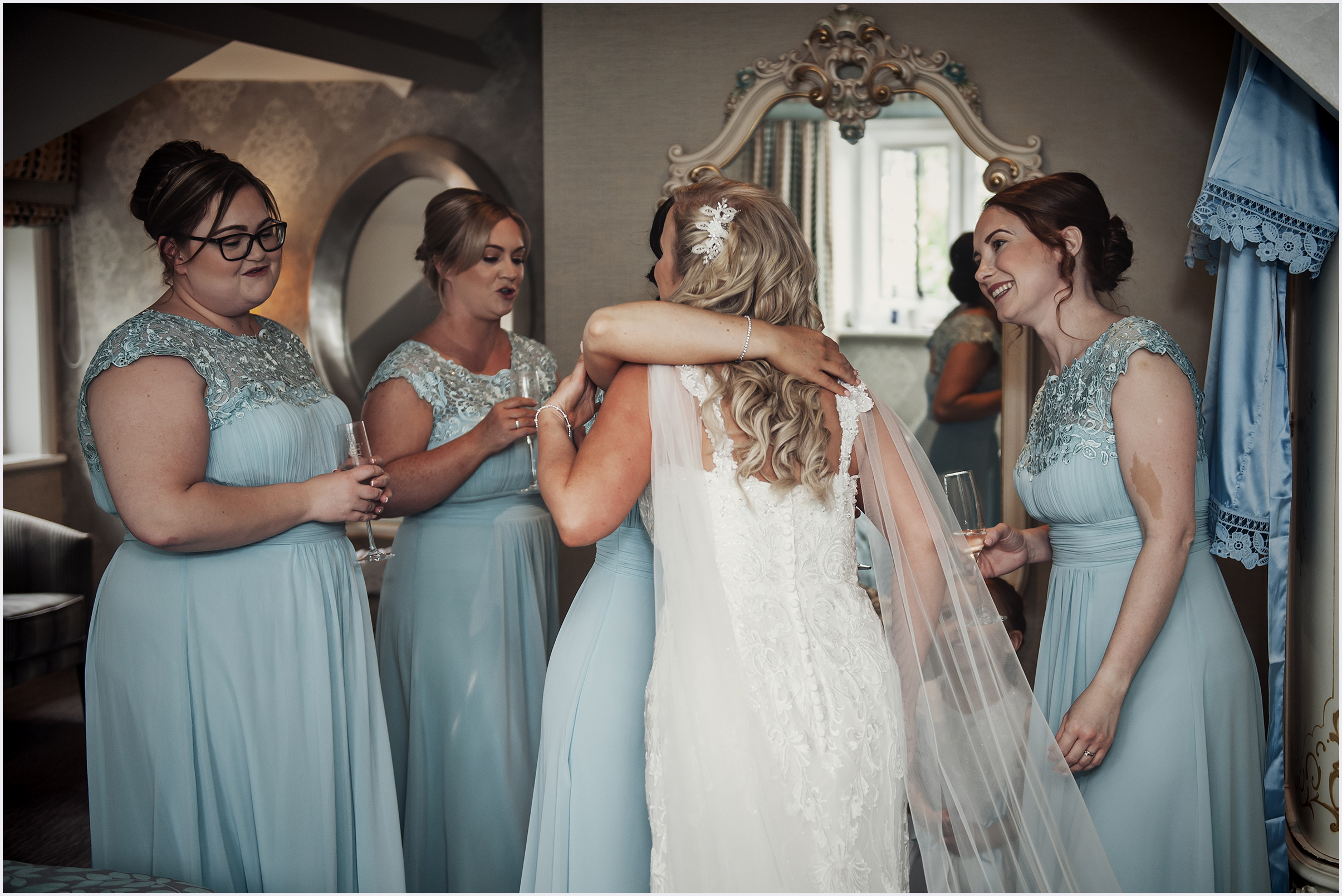 A bride hugs one of her bridesmaids before she marries at The Grosvebor Pulford Hotel and Spa