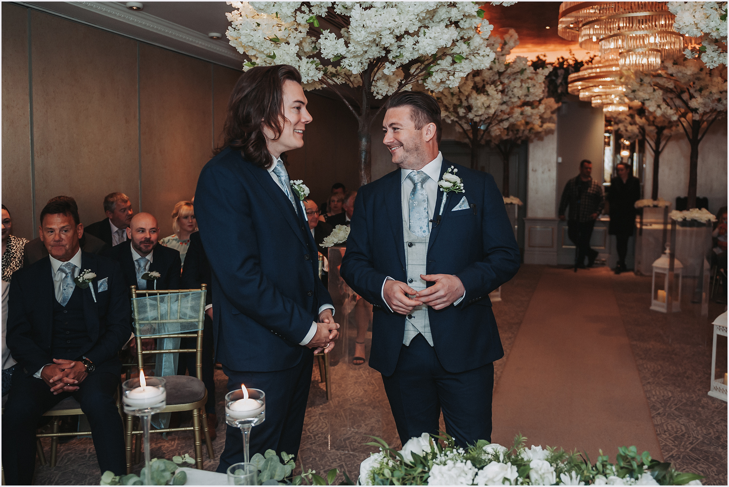 A groom chats with his best man at the top of the aisle waiting for his bride at The Grosvenor Pulford Hotel and Spa