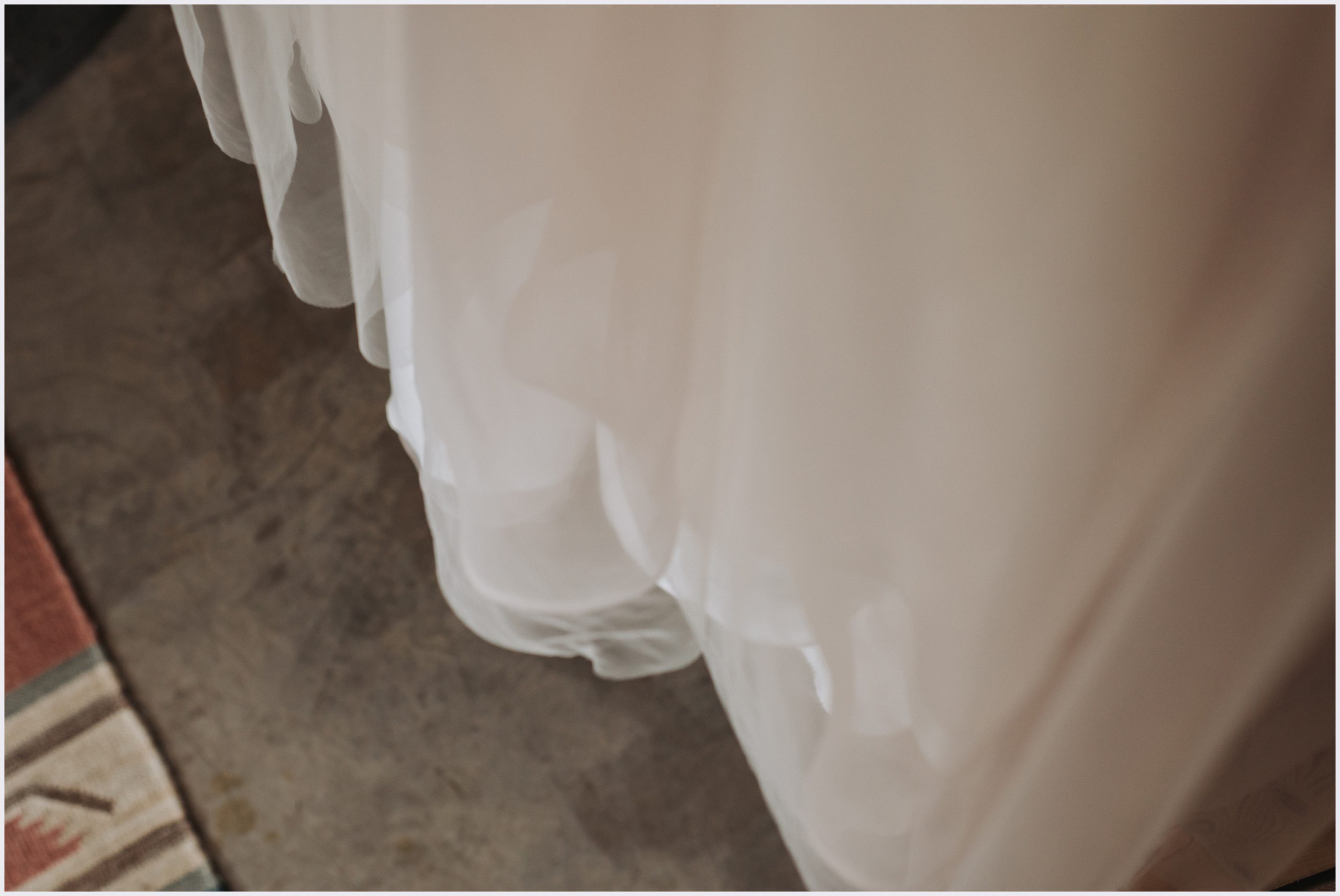 A close up shot of the bottom of a bride's beautiful wedding dress taken by Grosvenor Pulford Hotel and Spa Wedding Photographer Helena Jayne Photography