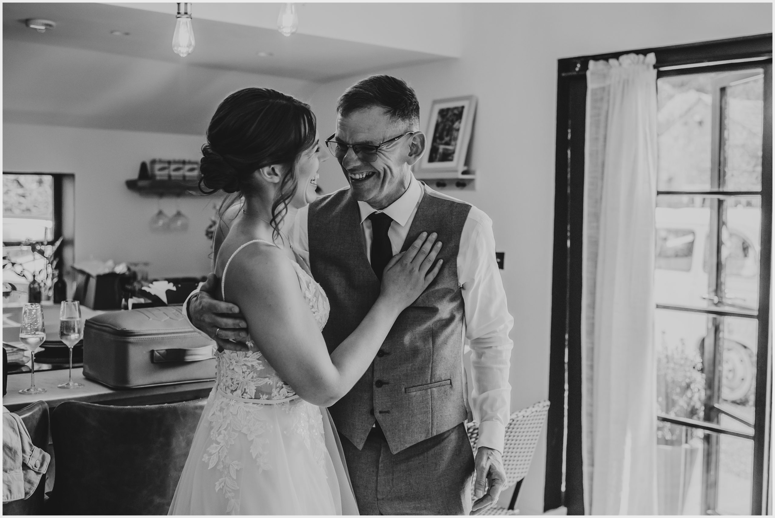 A beaming proud father of the bride embraced his daughter after seeing her for the first time in her wedding dress.  Image captured by Helena Jayne Photography