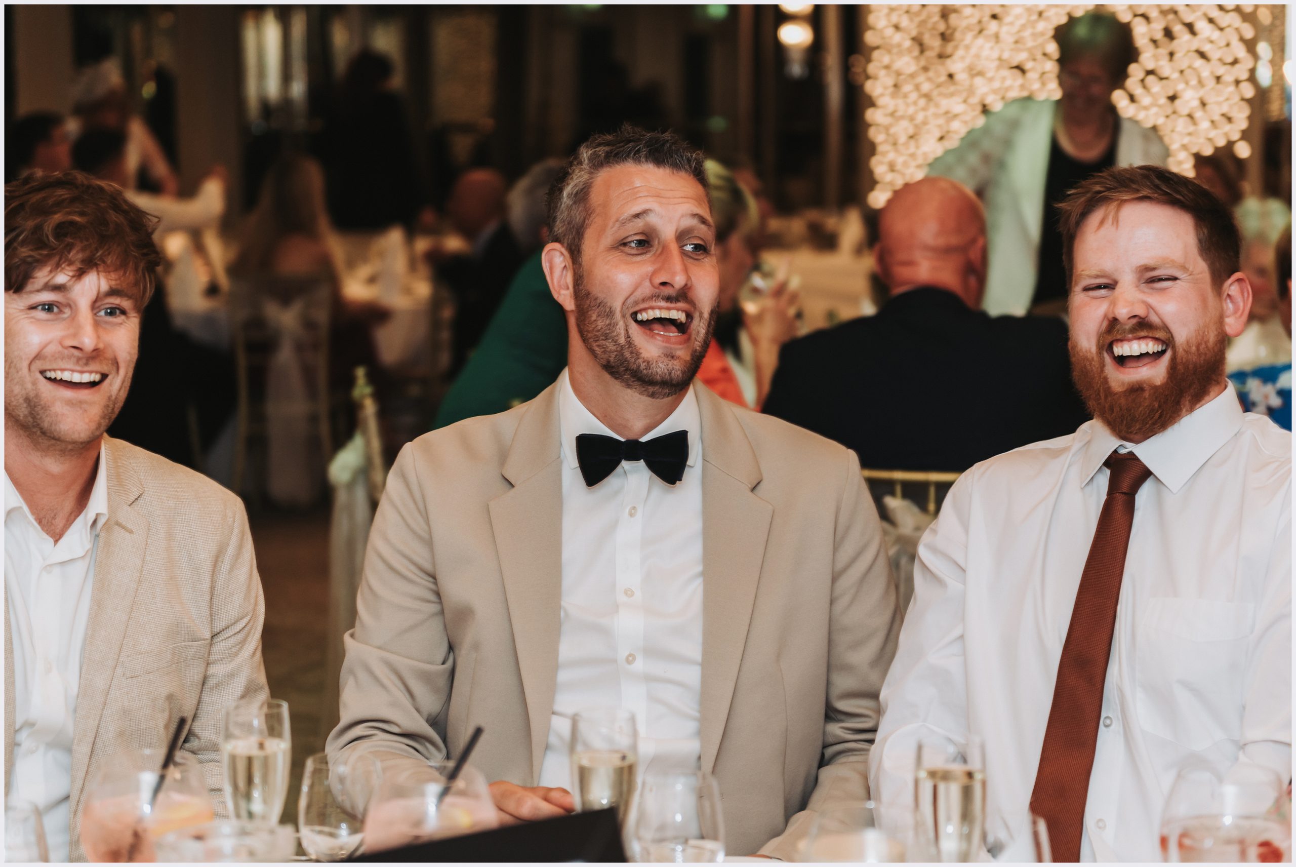 Guests joke and laugh before the speeches and wedding breakfast at the Grosvenor Pulford Hotel and Spa.  Image captured by Helena Jayne Photography