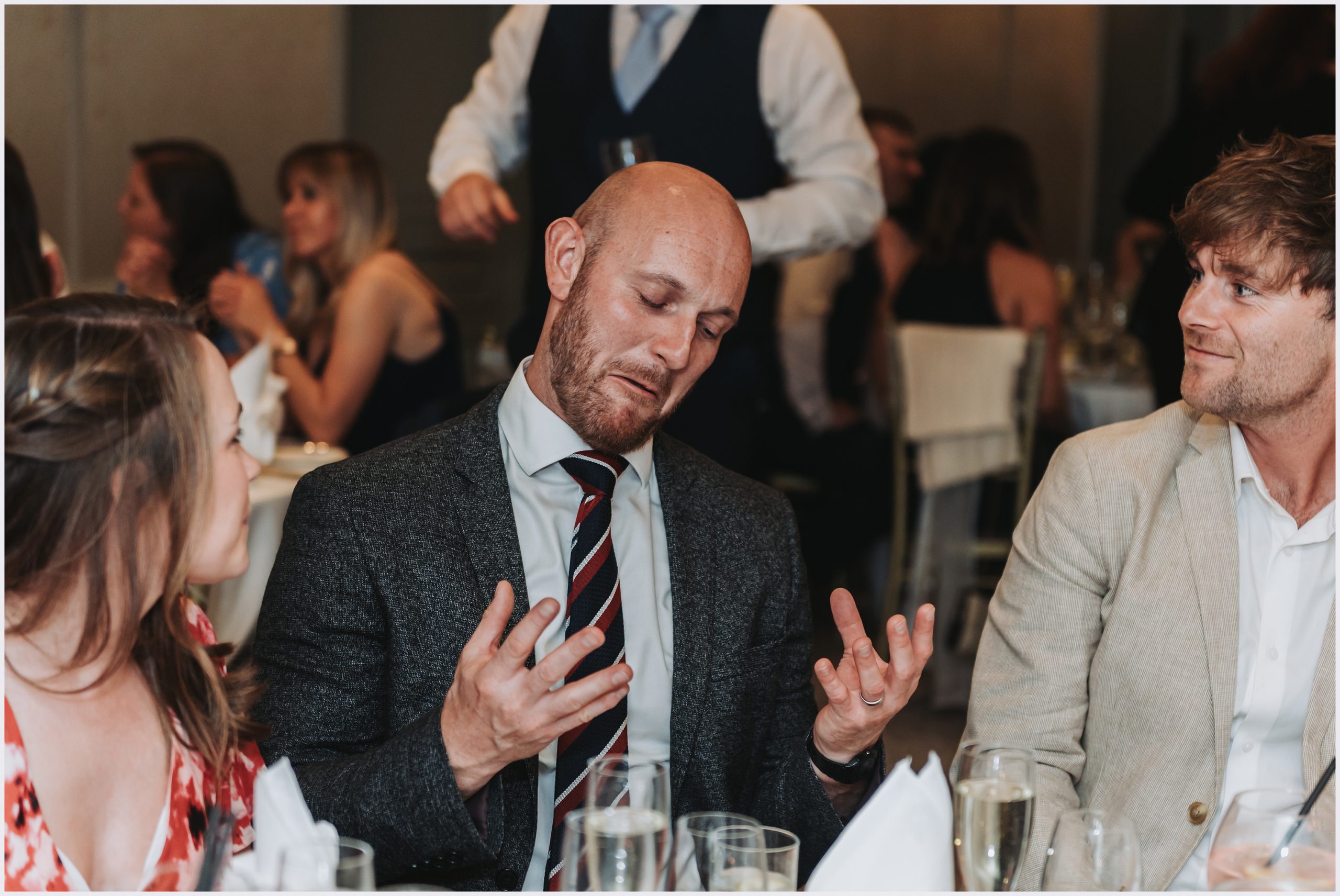 Guests joke and laugh before the speeches and wedding breakfast at the Grosvenor Pulford Hotel and Spa.  Image captured by Helena Jayne Photography