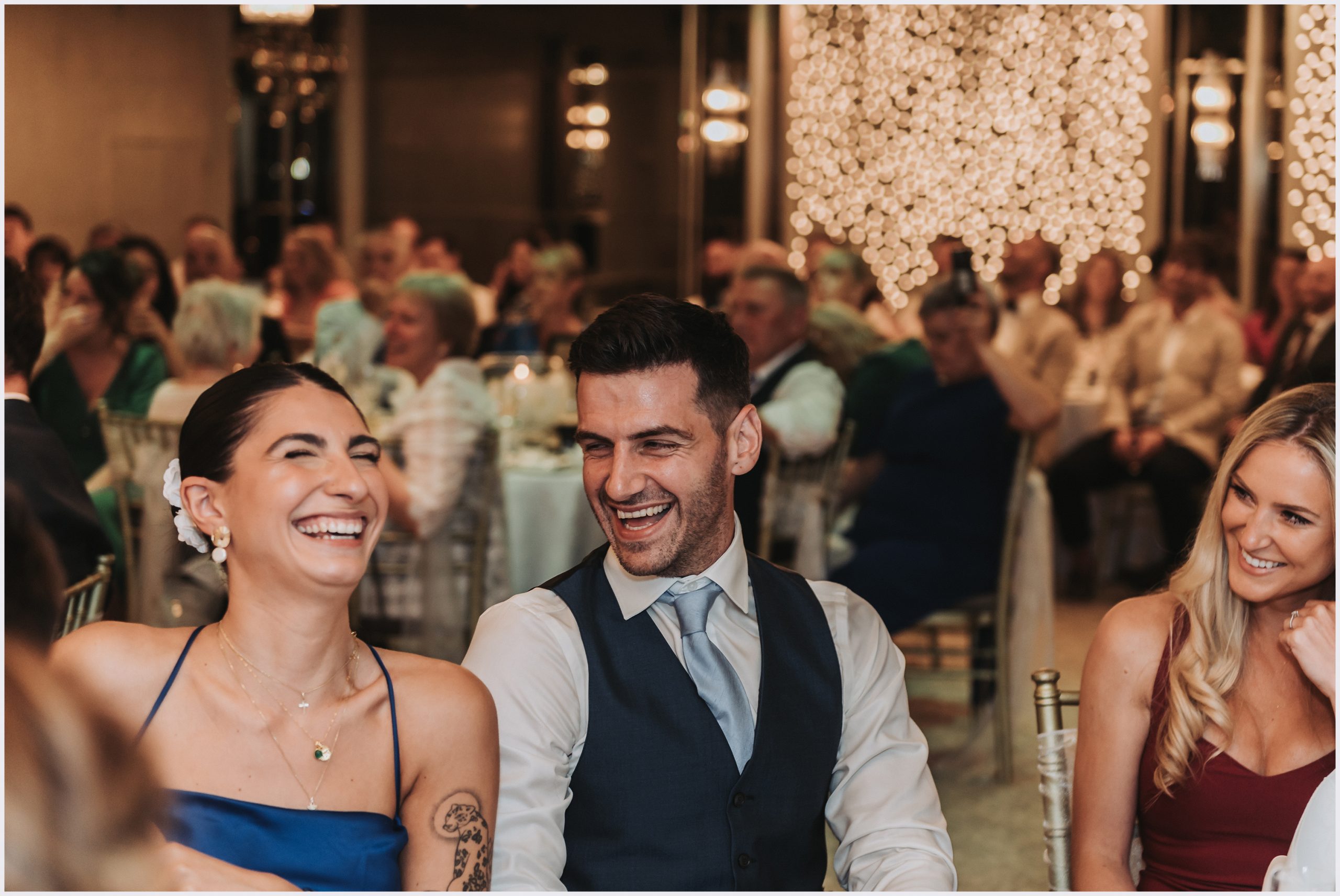Guests laughing while the speeches are read