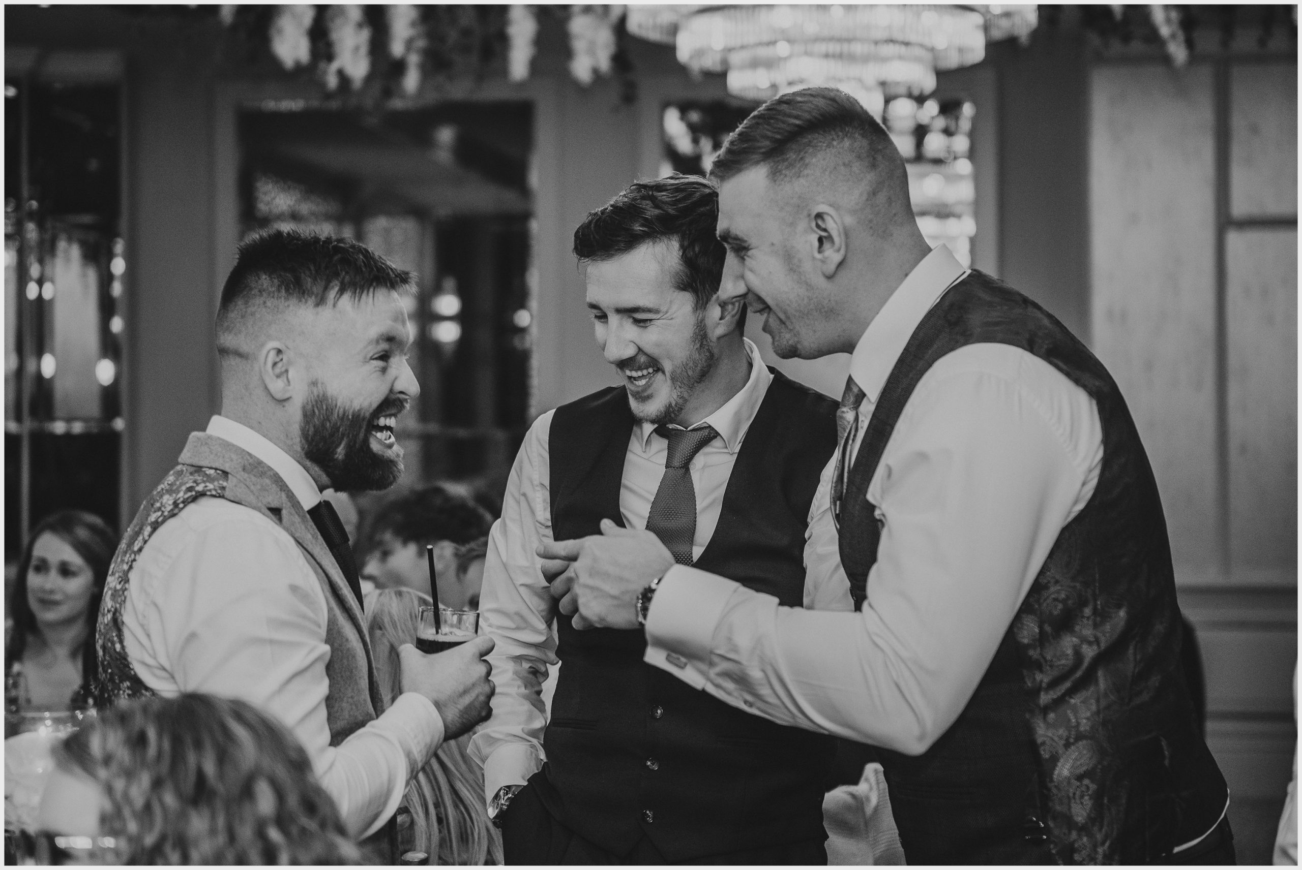 Guests joke and laugh during the wedding reception at The Grosvenor Pulford Hotel and Spa.  Image taken by north Wales based wedding photographer Helena Jayne Photography