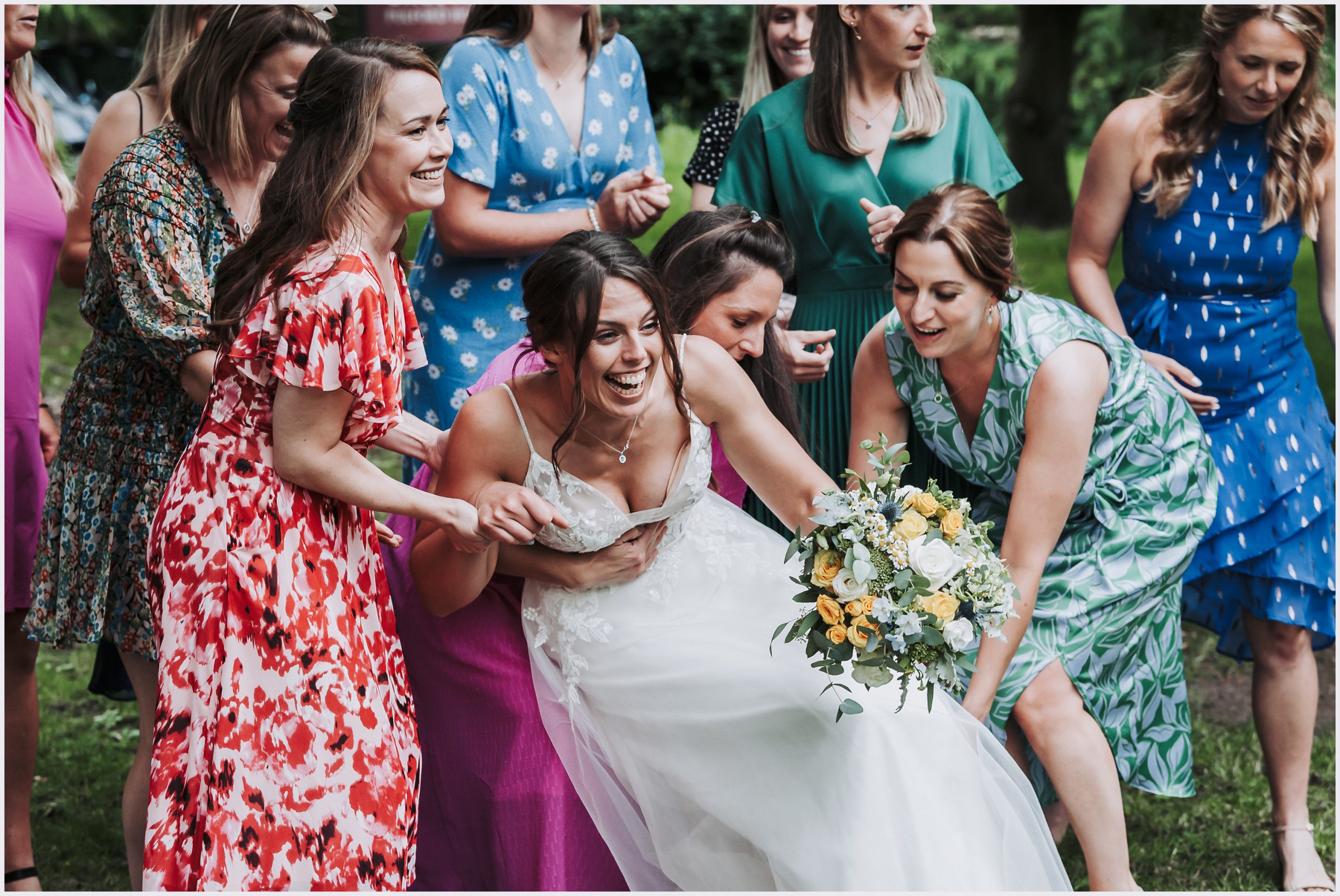A bride falls over while joking with her girl friends.