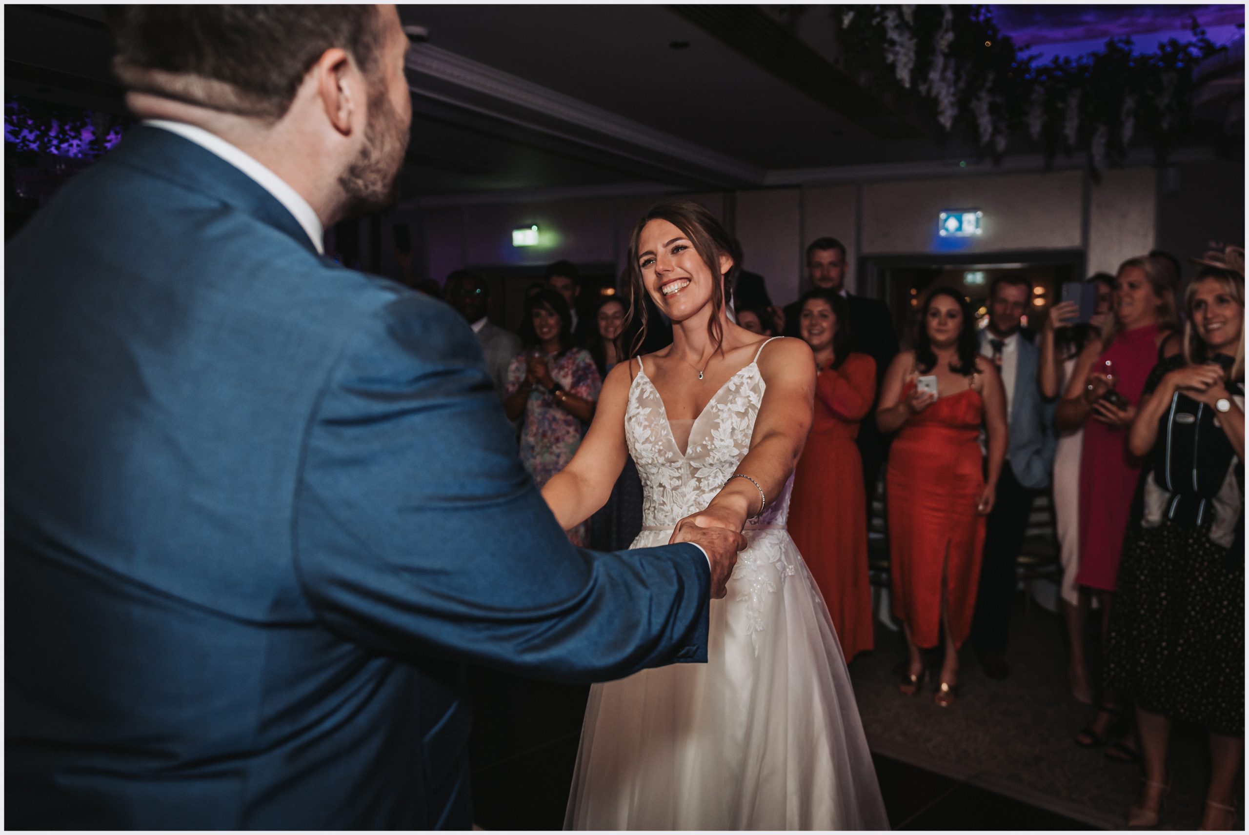 A beautiful bride smiles happily at her husband during their first dance at The Grosvenor Pulford Hotel and Spa.  Image captured by Cheshire wedding photographer Helena Jayne Photography