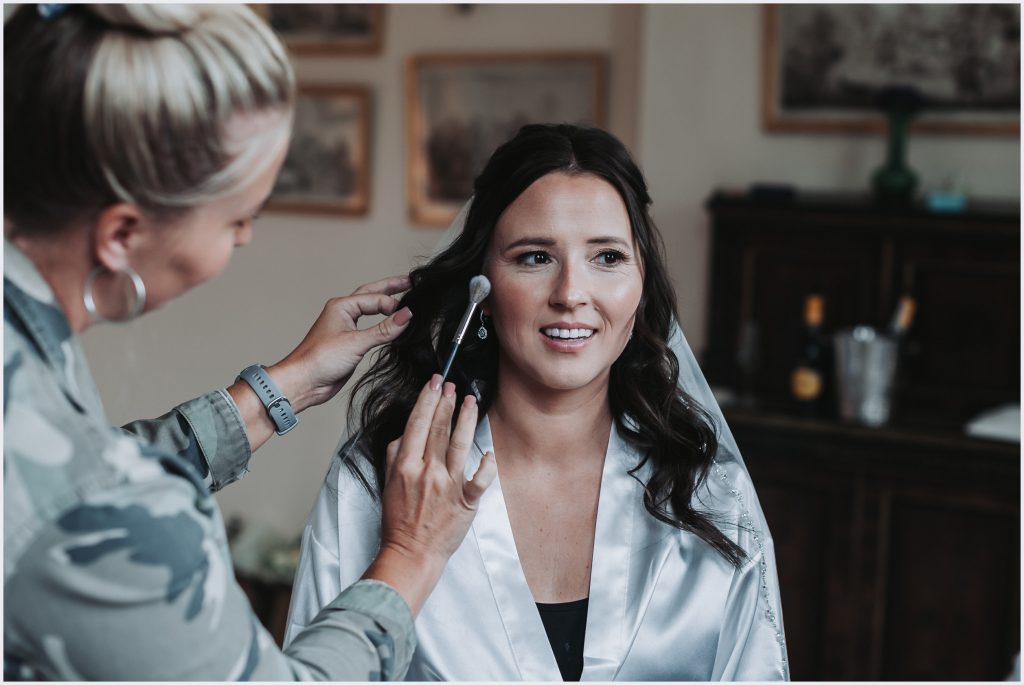 A beautiful brids has her make-up applied during morning preparations at Iscoyd Park. Image captured by North Wlaes based wedding photographer Helena Jayne Photography.