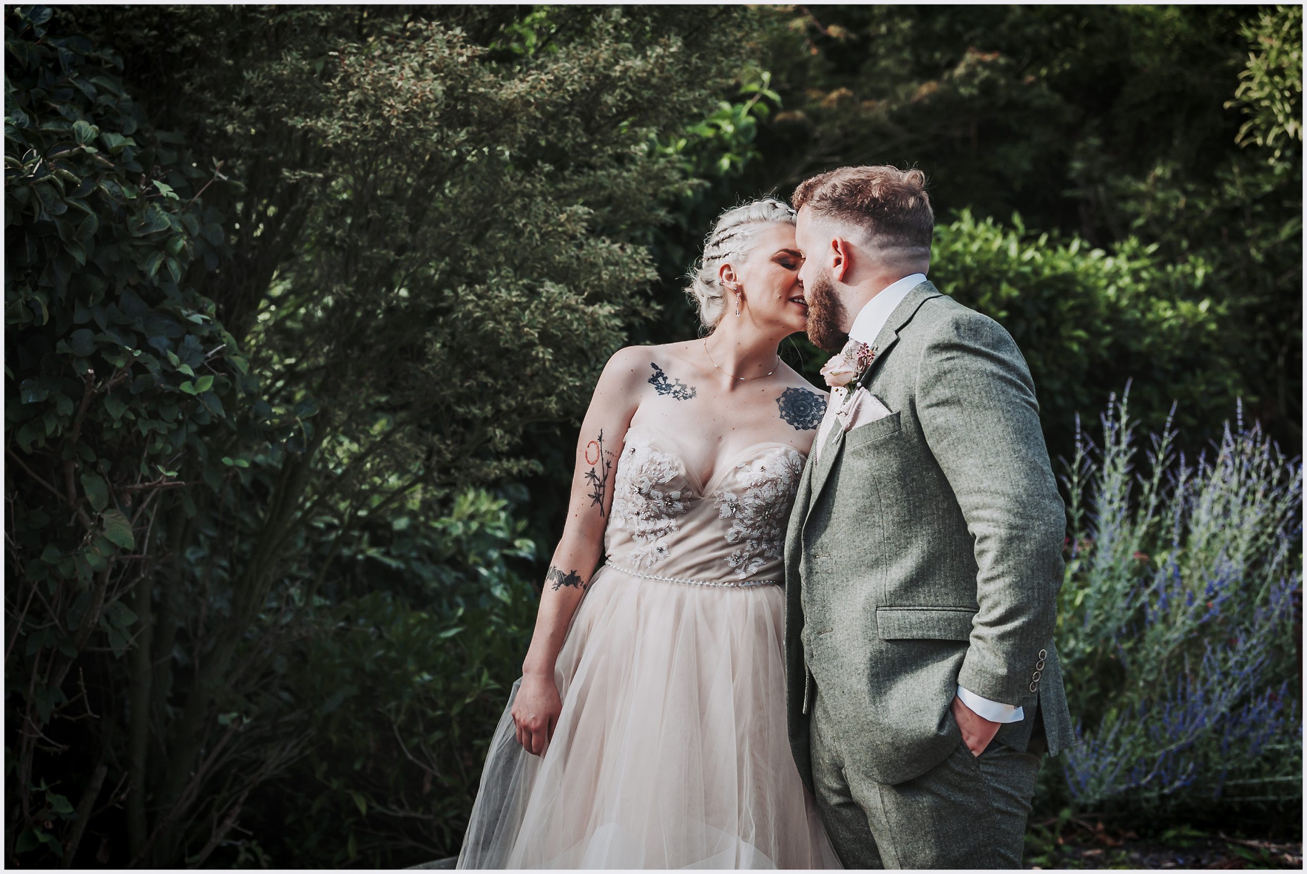 A bride and groom embrace in the Asian gardens at The Grosvenor Pulford Hotel and Spa.  Image captured by Helena Jayne Photography, Cheshire wedding photographer