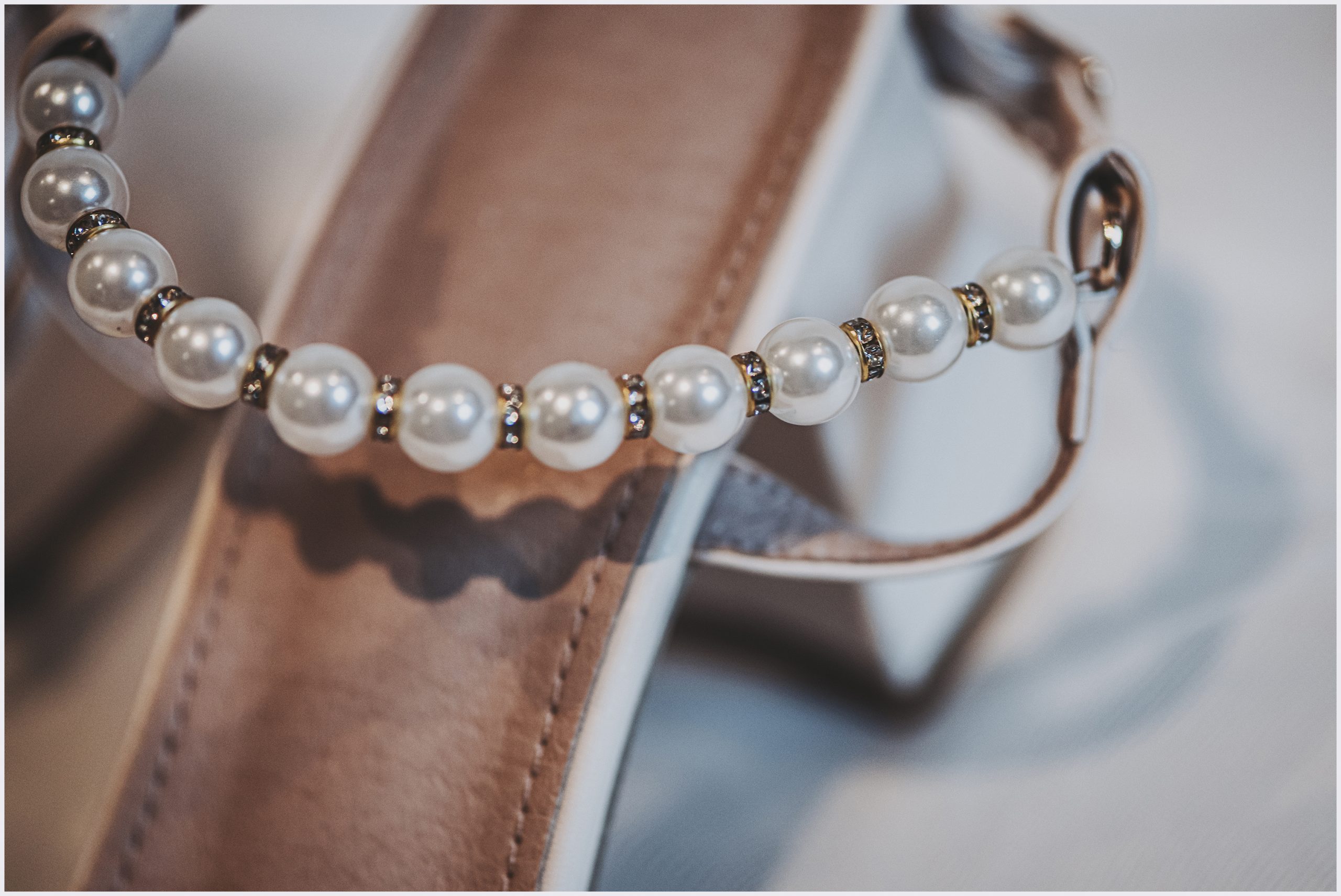 A close up shot of the beeded detail of a bride's wedding shoe