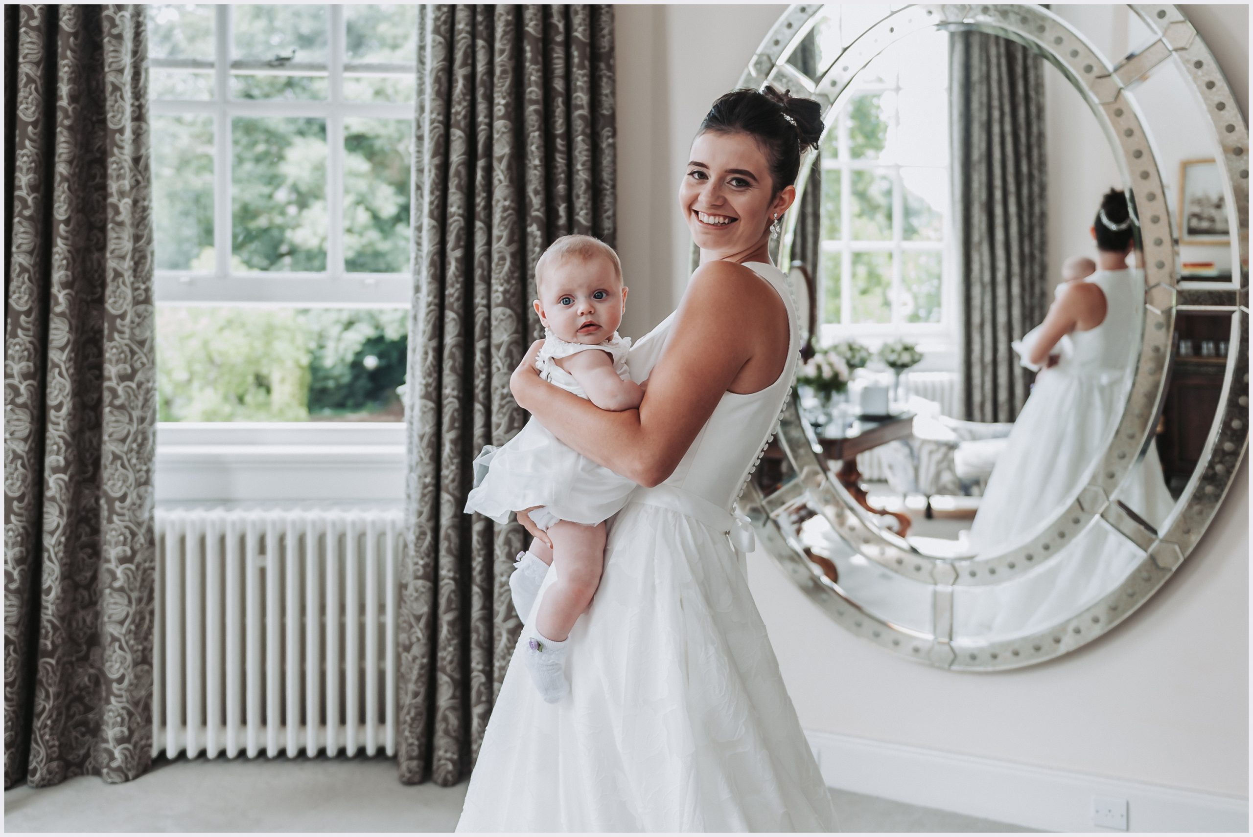 A beautfiul bride and her daughter pose for a wedding portrait in the beautiful dressing room at Iscoyd Park on the morning of her wedding.  Image captured by Helena Jayne Photography