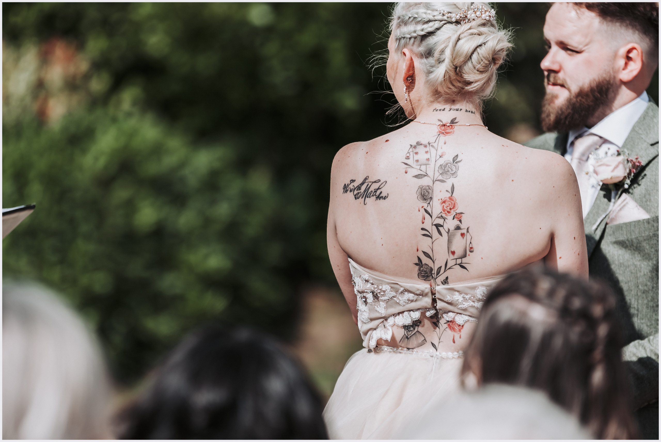 A close up shot of a bride's beautiful tattooed back during the outdoor ceremony at The Grosvenor Pulford Hotel and Spa