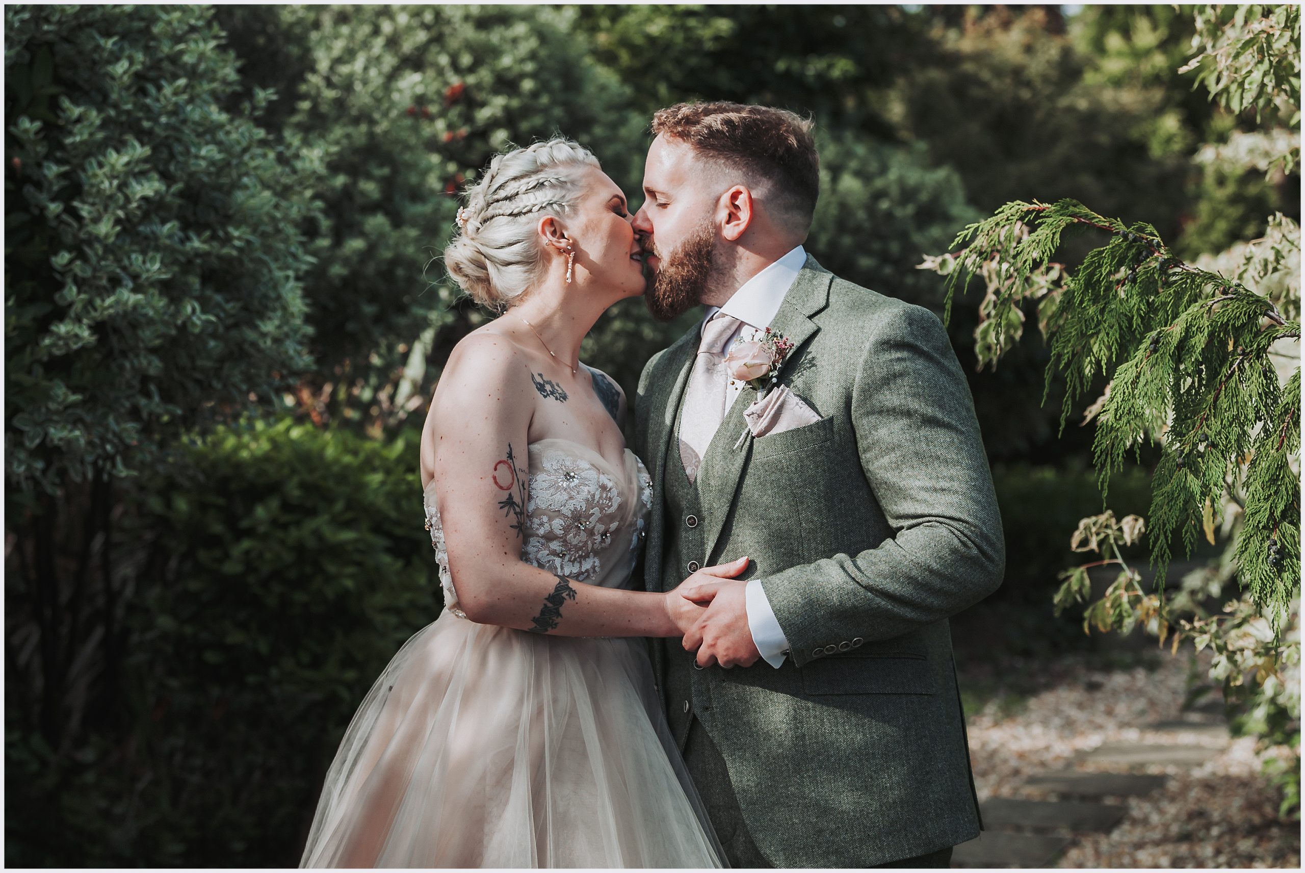 Capturing North Wales' Wedding Splendor: Bride and Groom's Intimate Portrait.  A bride and groom share a kiss at The Grosvenor Pulford Hotel and Spa